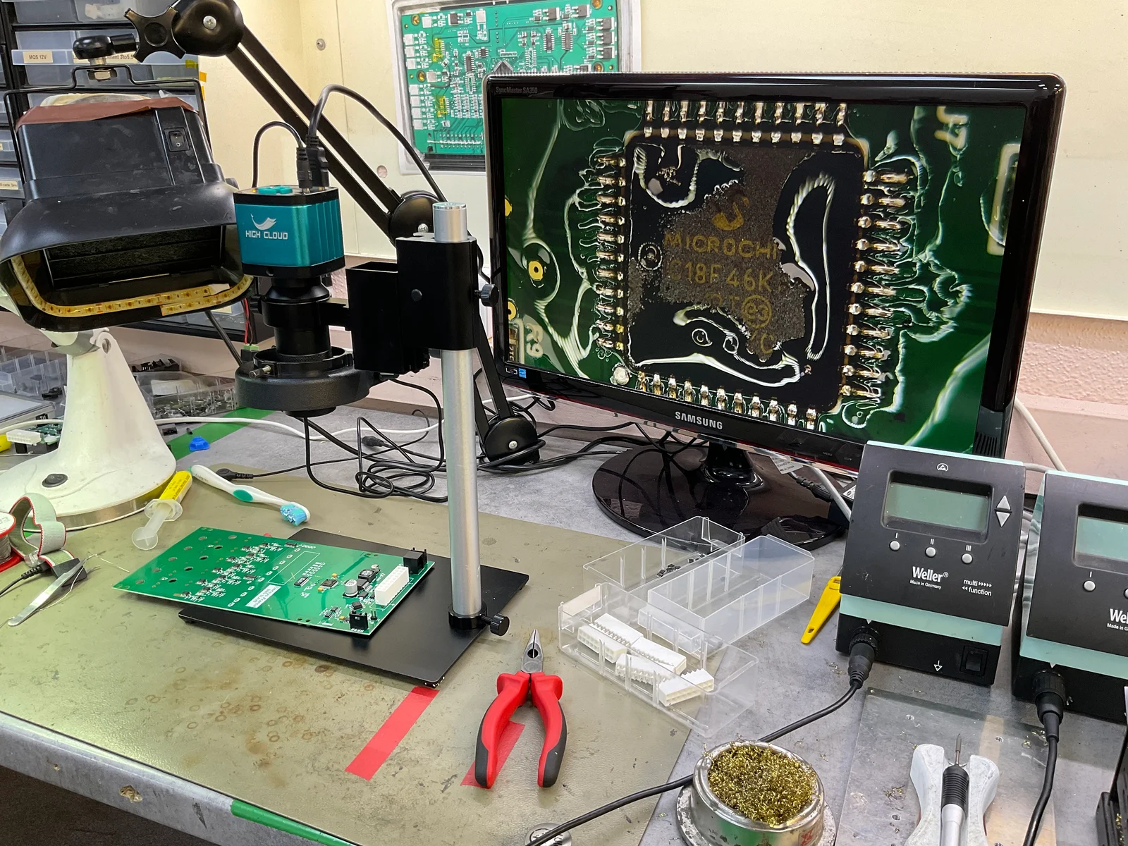 Soldering station with a microcontroller board under the magnifier lamp